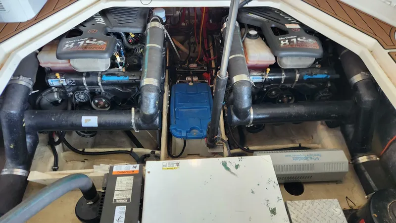 Slide: The Image of Engine compartment of a 2006 Regal Commodore 3560 IB boat, featuring dual engines and piping. - 24