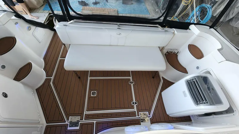 Slide: The Image of 2006 Regal Commodore 3560 IB boat interior with white seating and wood flooring. - 27