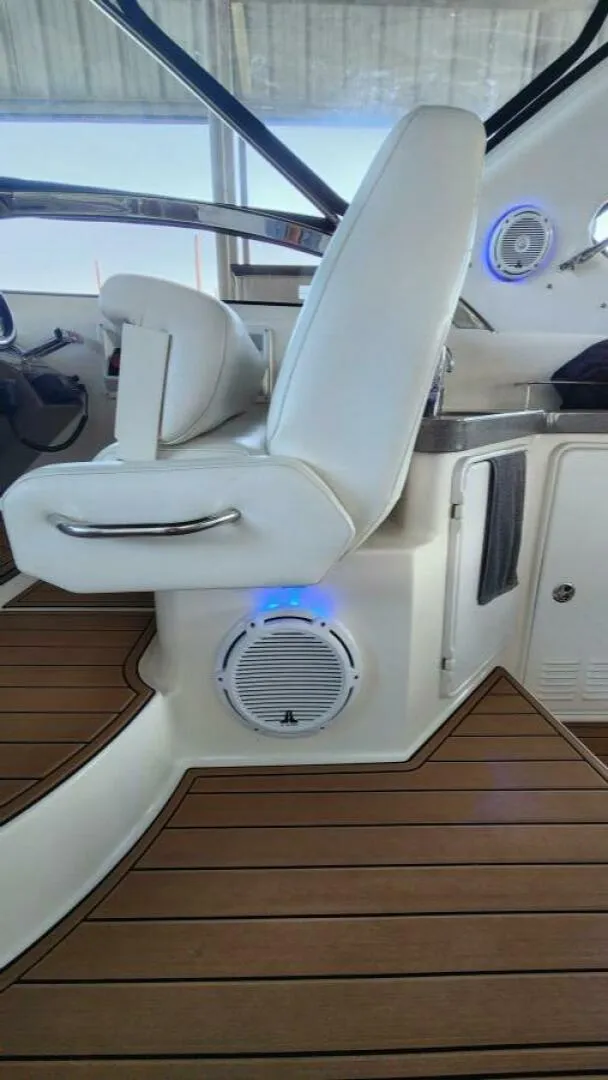 Slide: The Image of 2006 Regal Commodore 3560 IB helm with white seat and wood flooring. - 28