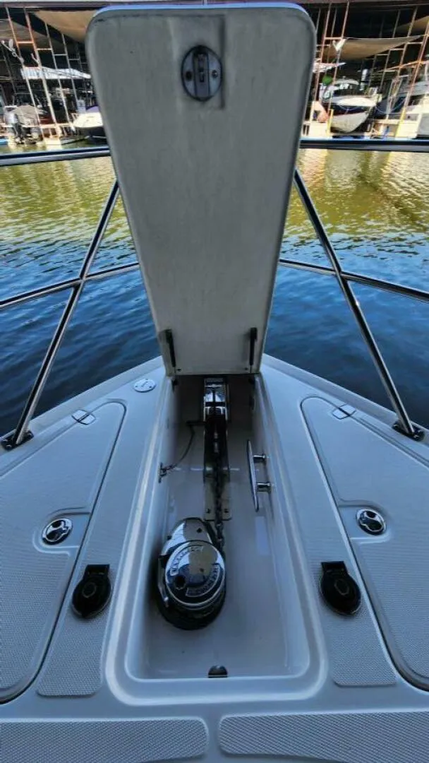 Slide: The Image of 2006 Regal Commodore 3560 IB boat anchor compartment open at marina. - 29
