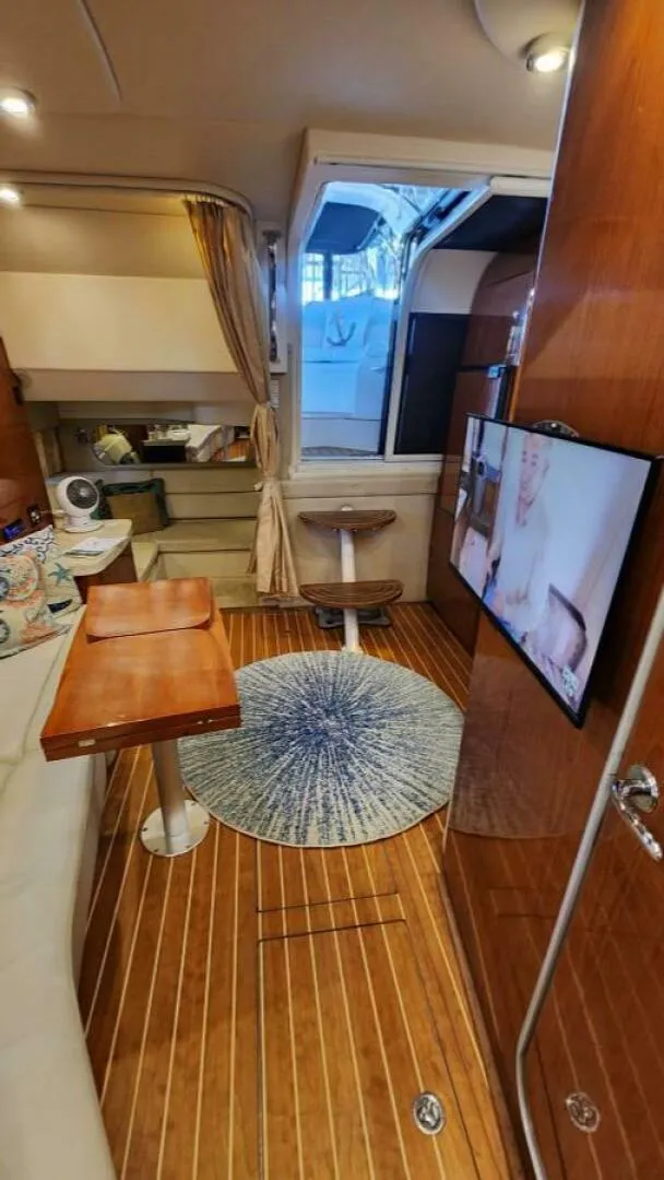 Slide: The Image of Interior of 2006 Regal Commodore 3560 IB yacht with wood flooring and modern amenities. - 3