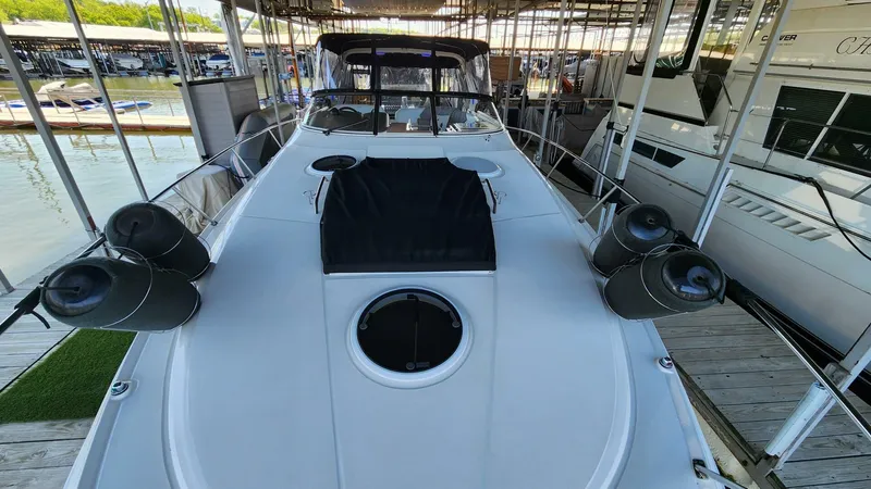 Slide: The Image of 2006 Regal Commodore 3560 IB yacht docked in marina, showcasing sleek design and spacious deck. - 32