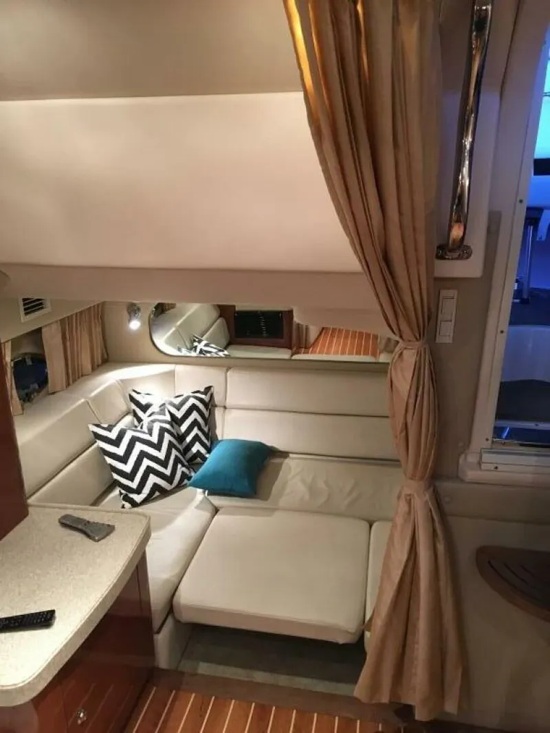 Slide: The Image of Interior of 2006 Regal Commodore 3560 IB yacht with cozy seating and decorative pillows. - 6