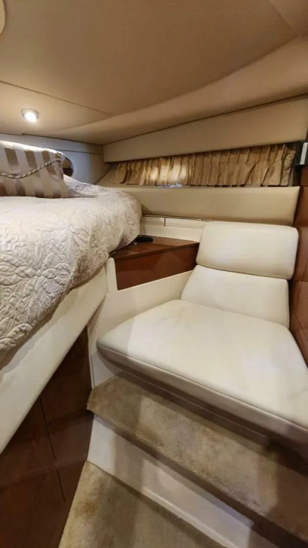 Slide: The Image of Interior of 2006 Regal Commodore 3560 IB yacht with cozy seating and elegant bedding. - 9