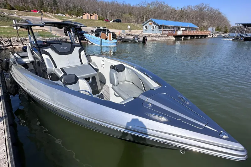 Slide: The Image of 2017 Sunsation 32 CCX boat docked on a calm lake. - 11