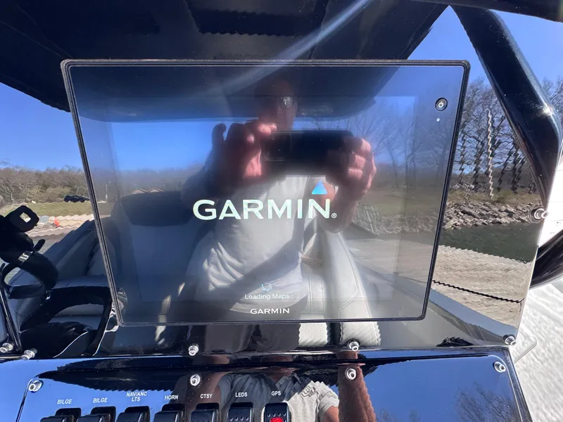 Slide: The Image of Garmin display on 2017 Sunsation 32 CCX boat dashboard, reflecting outdoor scenery. - 15