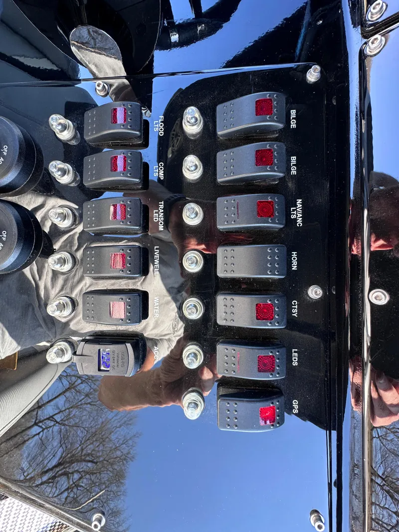 Slide: The Image of Control panel of a 2017 Sunsation 32 CCX boat with labeled switches. - 17