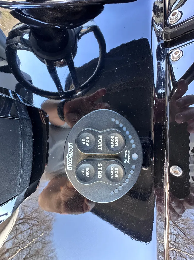 Slide: The Image of Control panel of a 2017 Sunsation 32 CCX boat with Lenco trim tab switches. - 19