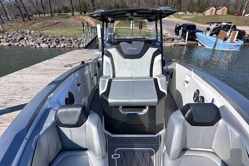 Slide: The Image of 2017 Sunsation 32 CCX boat interior with sleek seating and modern design at a dock. - 20