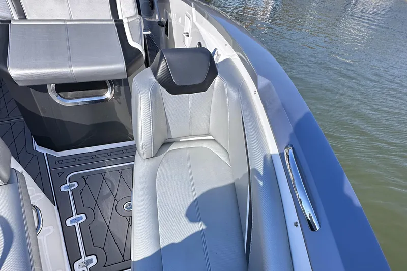 Slide: The Image of 2017 Sunsation 32 CCX boat interior with gray seating and water view. - 22
