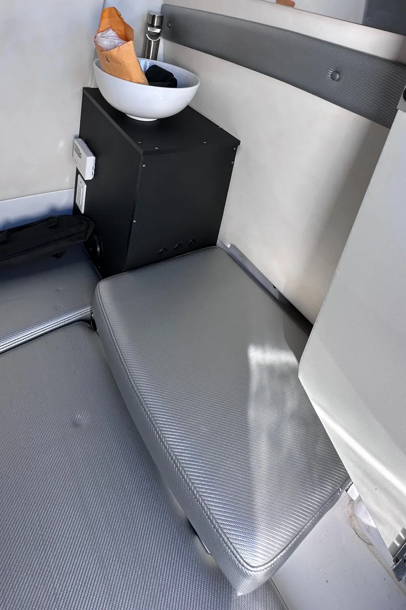 Slide: The Image of Interior of 2017 Sunsation 32 CCX boat with gray seating and storage compartment. - 29