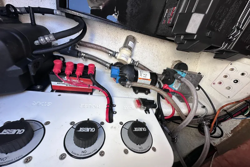 Slide: The Image of Electrical and plumbing components inside a 2017 Sunsation 32 CCX boat. - 32