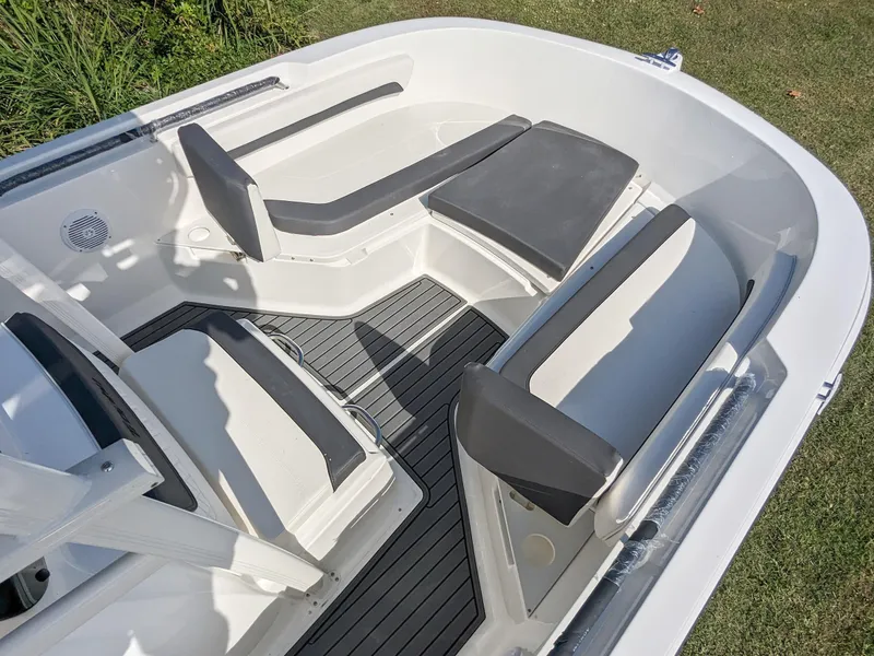Slide: The Image of 2025 Bayliner Trophy T22CC boat interior with cushioned seating and sleek design. - 4