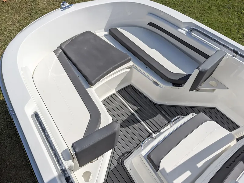 Slide: The Image of 2025 Bayliner Trophy T22CC boat interior with cushioned seating and sleek design. - 5