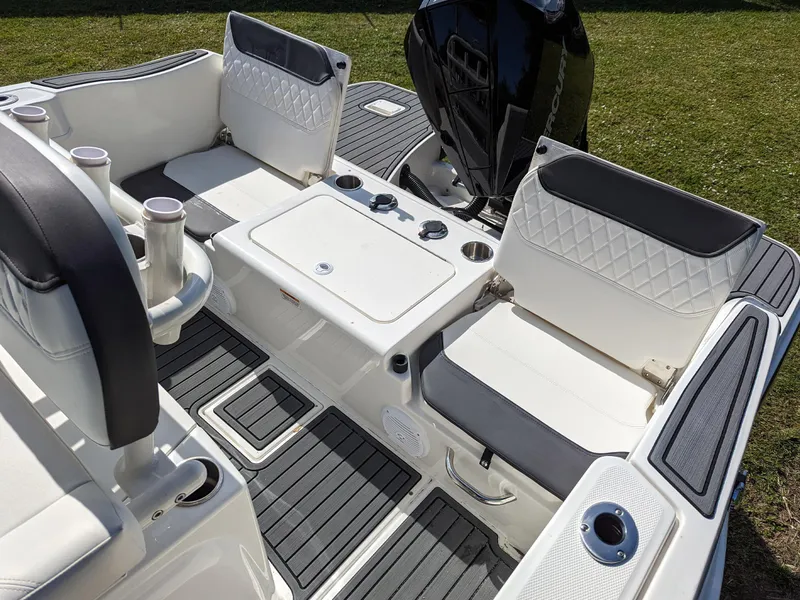 Slide: The Image of 2025 Bayliner Trophy T22CC boat interior with seating and storage compartments. - 6