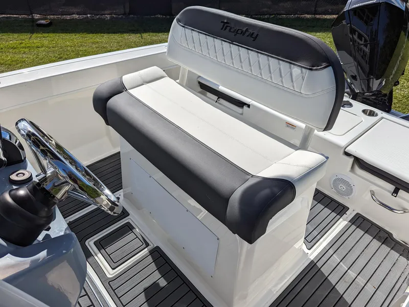 Slide: The Image of 2025 Bayliner Trophy T22CC boat interior with cushioned seating and steering wheel. - 8