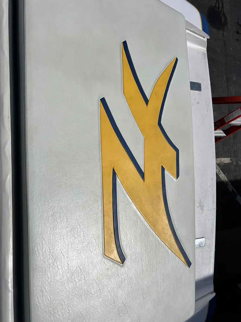 Slide: The Image of 1998 Donzi 33ZX logo on white surface, featuring a bold yellow design. - 11