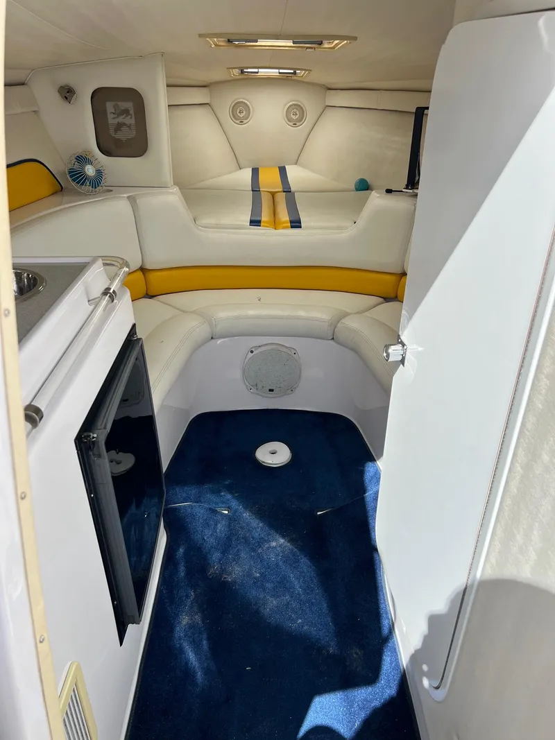 Slide: The Image of Interior of a 1998 Donzi 33ZX boat with white and yellow seating. - 12