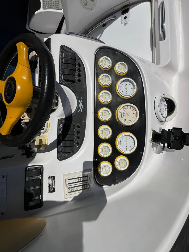 Slide: The Image of 1998 Donzi 33ZX dashboard with yellow steering wheel and multiple gauges. - 15