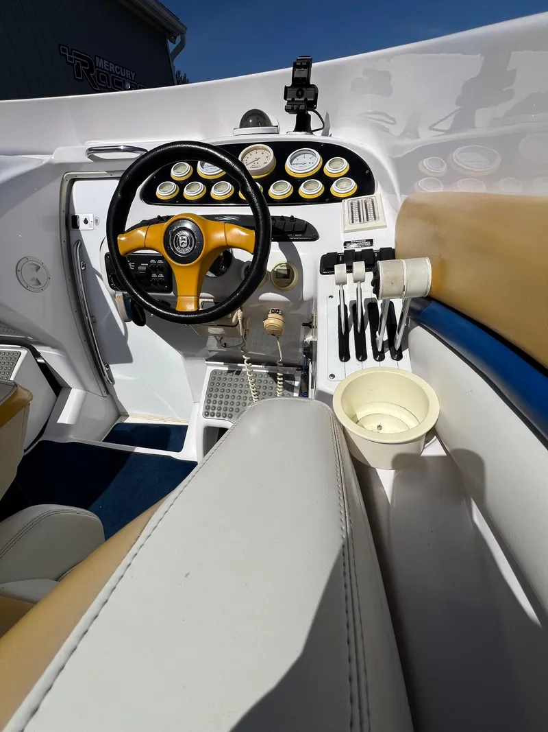 Slide: The Image of 1998 Donzi 33ZX boat cockpit with steering wheel, gauges, and controls. - 16