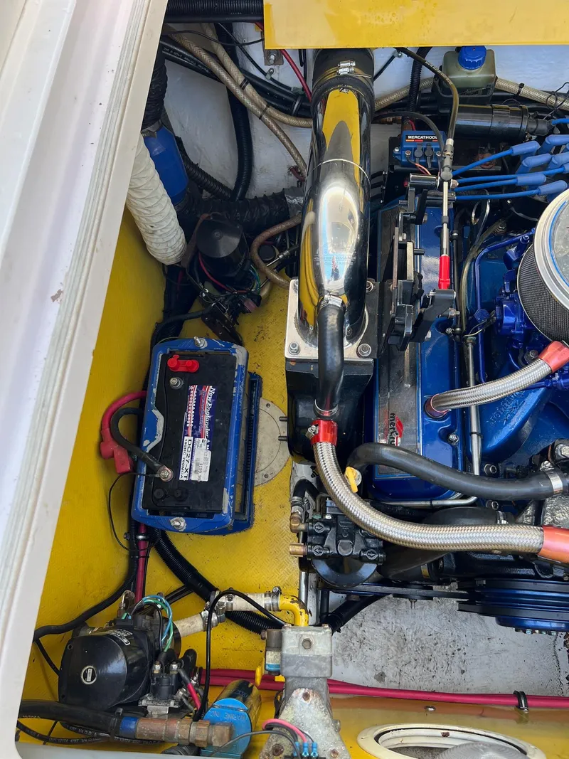 Slide: The Image of Engine compartment of a 1998 Donzi 33ZX boat, featuring battery and mechanical components. - 19