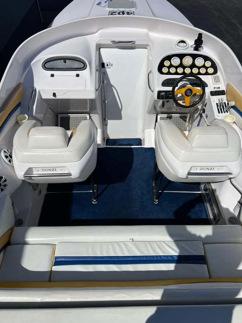 Slide: The Image of 1998 Donzi 33ZX boat interior with dual seats, steering wheel, and dashboard controls. - 20
