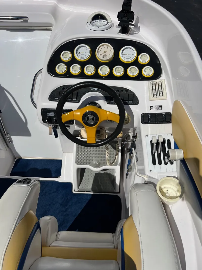 Slide: The Image of Cockpit of a 1998 Donzi 33ZX boat with yellow steering wheel and instrument panel. - 21