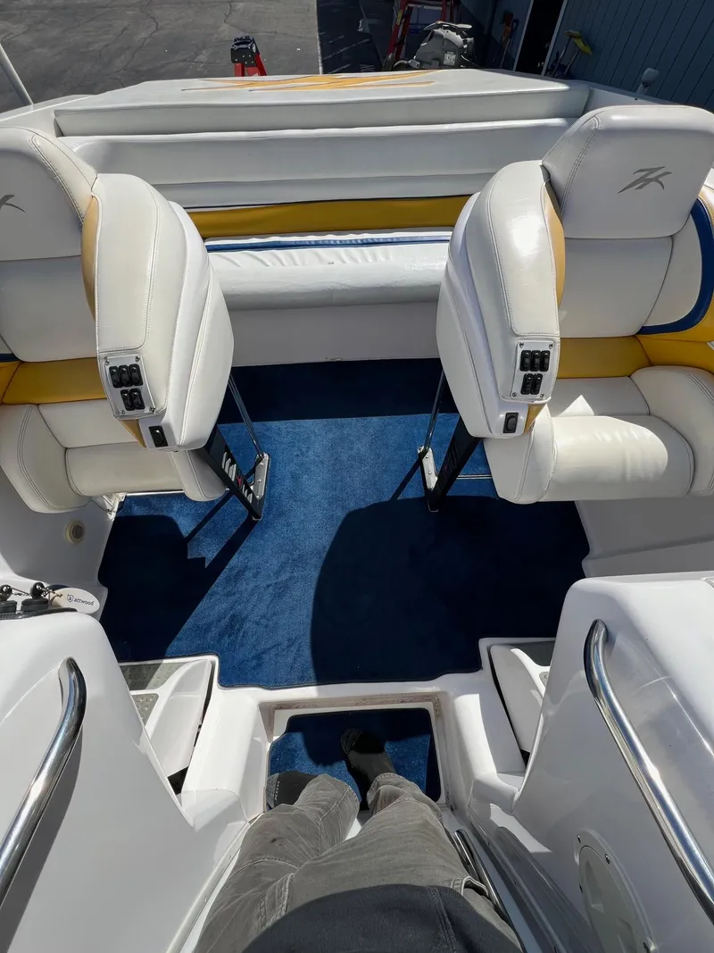 Slide: The Image of 1998 Donzi 33ZX boat interior with white and yellow seating, blue carpet. - 22