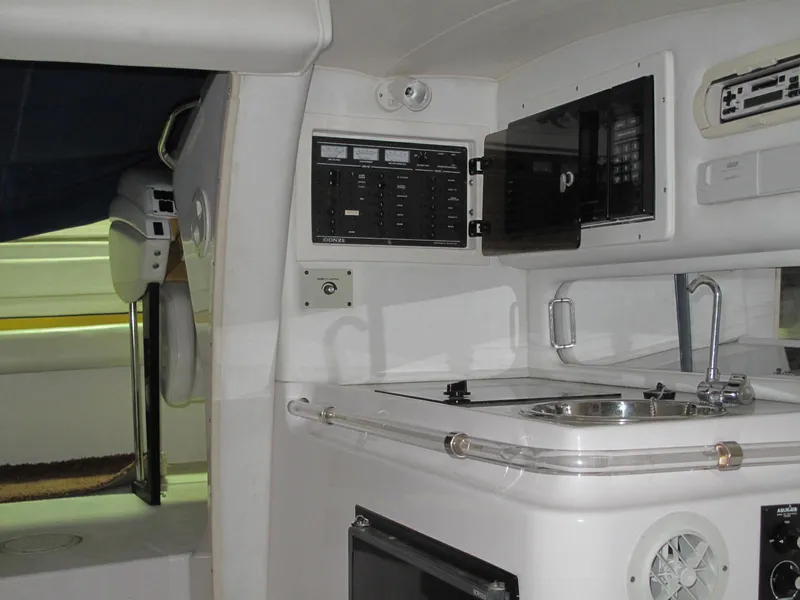 Slide: The Image of Interior of a 1998 Donzi 33ZX boat featuring a compact kitchen area. - 23