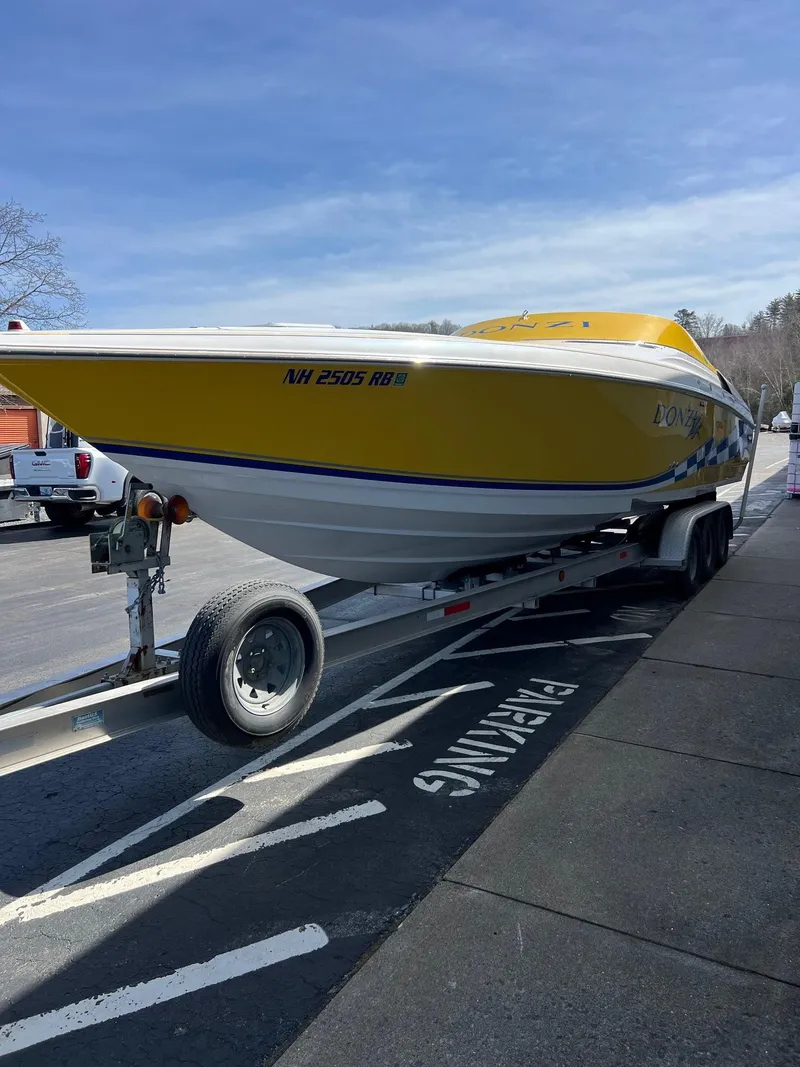 Slide: The Image of 1998 Donzi 33ZX speedboat in yellow on a trailer in a parking lot. - 7
