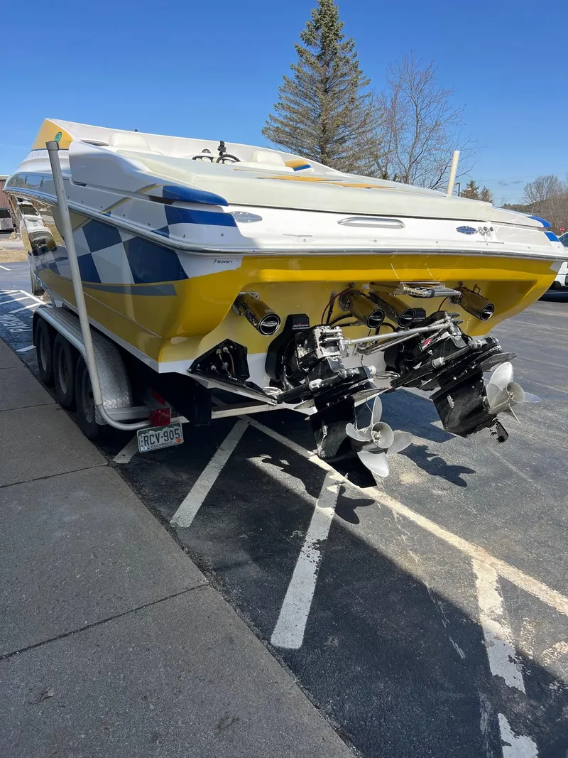 Slide: The Image of 1998 Donzi 33ZX boat on trailer, yellow and white, parked outdoors. - 9