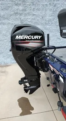Slide: The Image of 2019 Tracker Pro 170 boat with Mercury outboard motor, parked on concrete. - 11