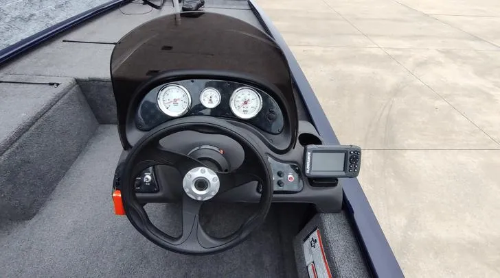 Slide: The Image of 2019 Tracker Pro 170 boat dashboard with steering wheel and gauges. - 7