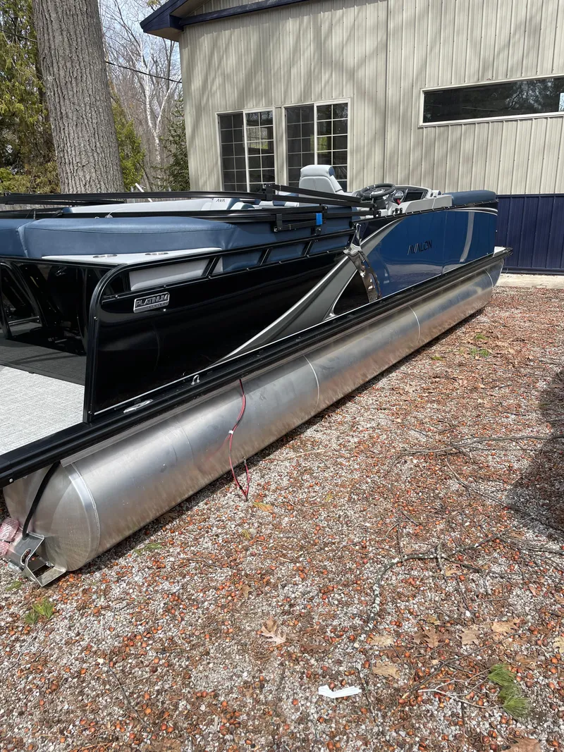 Slide: The Image of 2025 Avalon 25 LSZ ELITE pontoon boat parked outdoors near a building. - 1
