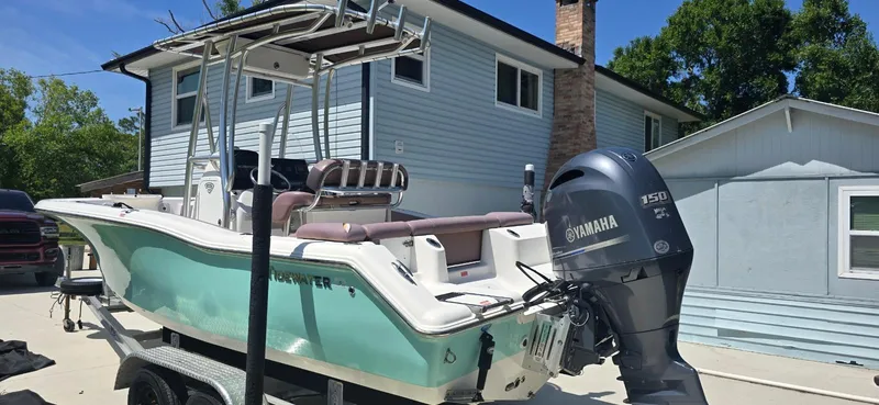 Slide: The Image of 2017 Tidewater 210 LXF boat with Yamaha engine parked near a house. - 3