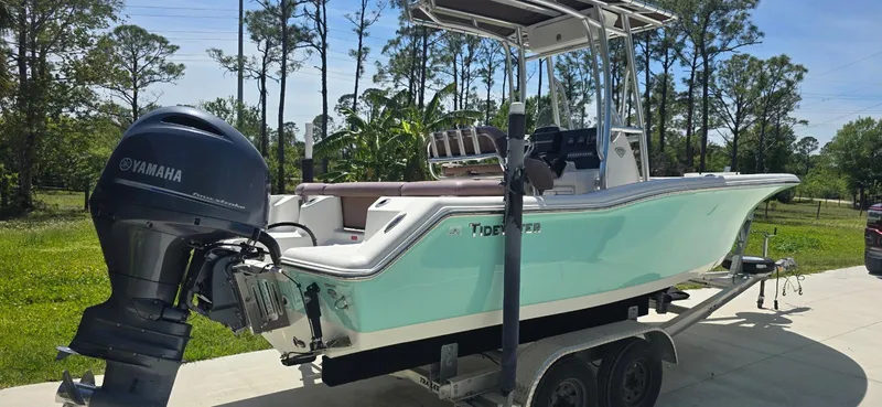 Slide: The Image of 2017 Tidewater 210 LXF boat on trailer with Yamaha outboard motor, parked outdoors. - 4