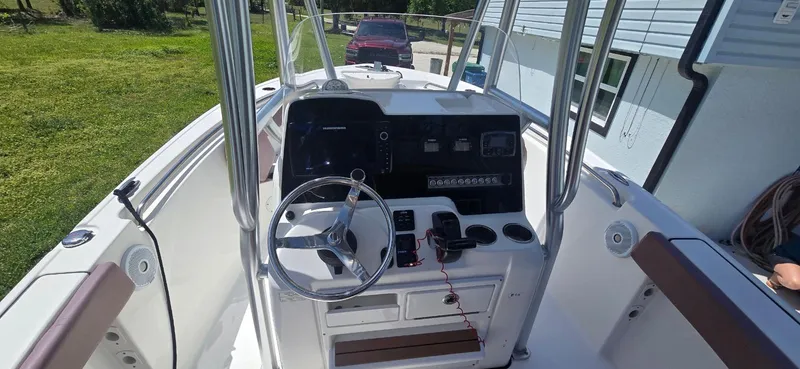 Slide: The Image of 2017 Tidewater 210 LXF boat interior with steering console and seating. - 7