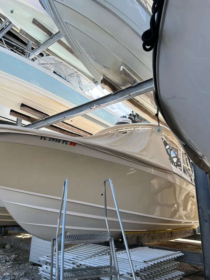 Slide: The Image of 2013 Grady-White Freedom 335 boat stored on a rack, side view. - 3