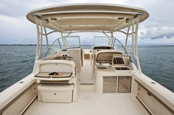 Slide: The Image of 2013 Grady-White Freedom 335 boat interior with helm, seating, and ocean view. - 4