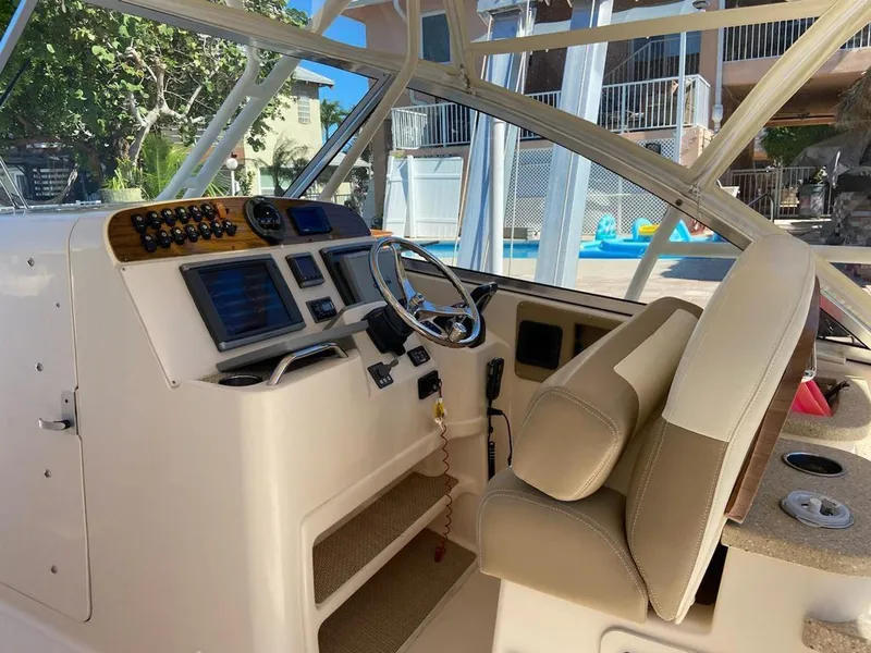 Slide: The Image of 2013 Grady-White Freedom 335 boat cockpit with steering wheel and control panel. - 6