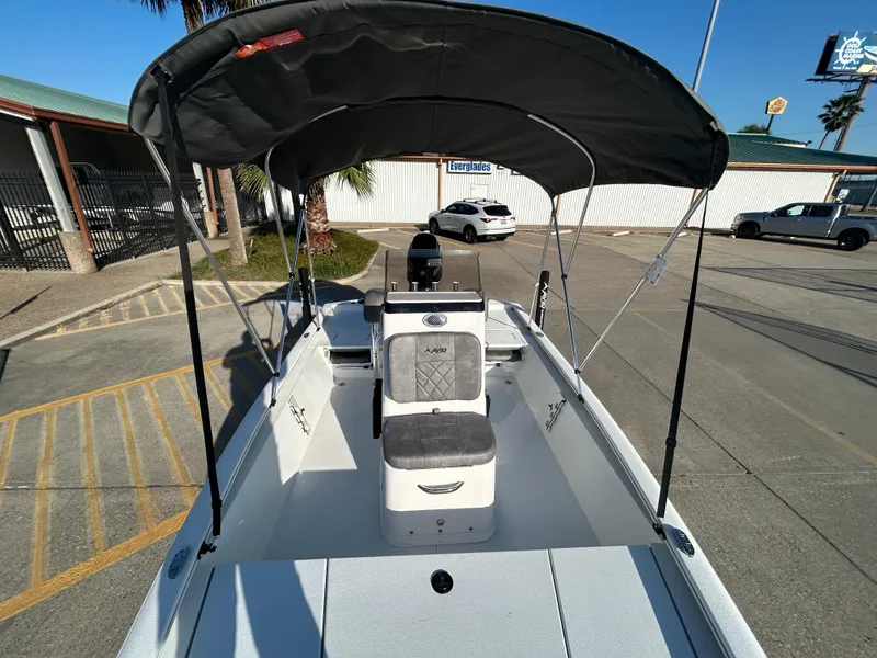 Slide: The Image of 2025 Avid 19 FSX boat with canopy, parked outdoors in a sunny setting. - 10