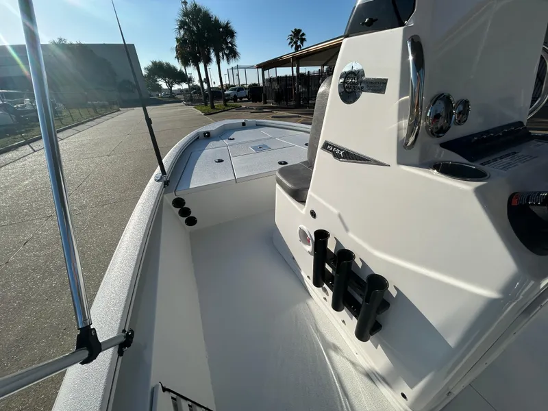 Slide: The Image of 2025 Avid 19 FSX boat, sleek white interior, docked under sunny skies. - 17