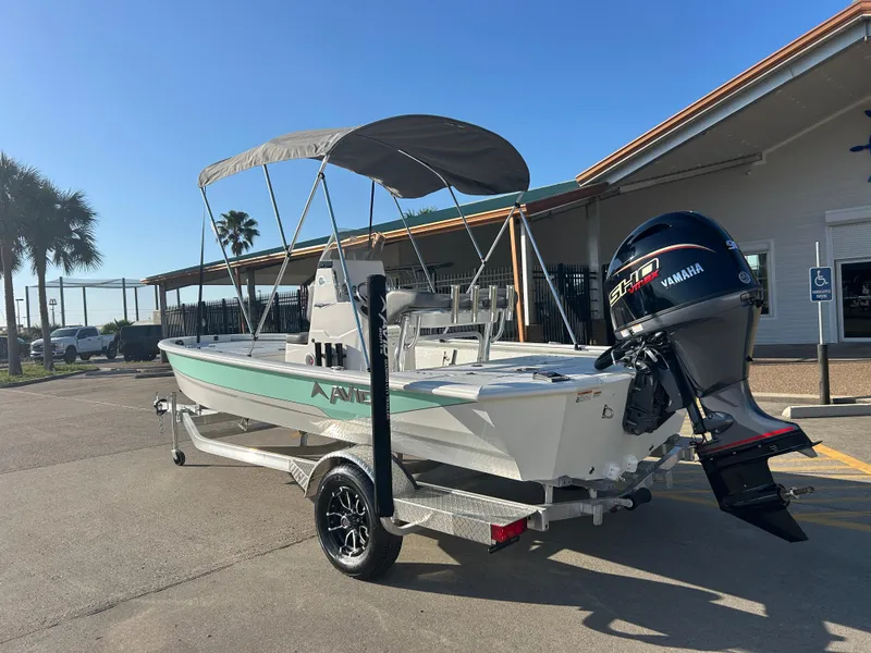 Slide: The Image of 2025 Avid 19 FSX boat with Yamaha motor on trailer, parked outdoors. - 5
