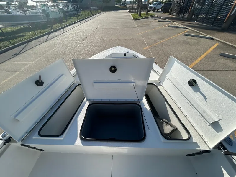 Slide: The Image of 2025 Avid 19 FSX boat storage compartments open, showcasing spacious interior design. - 9