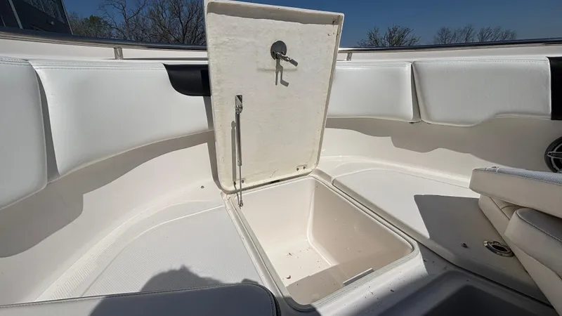 Slide: The Image of 2021 Robalo R302 Center Console boat storage compartment open, showcasing spacious interior. - 14