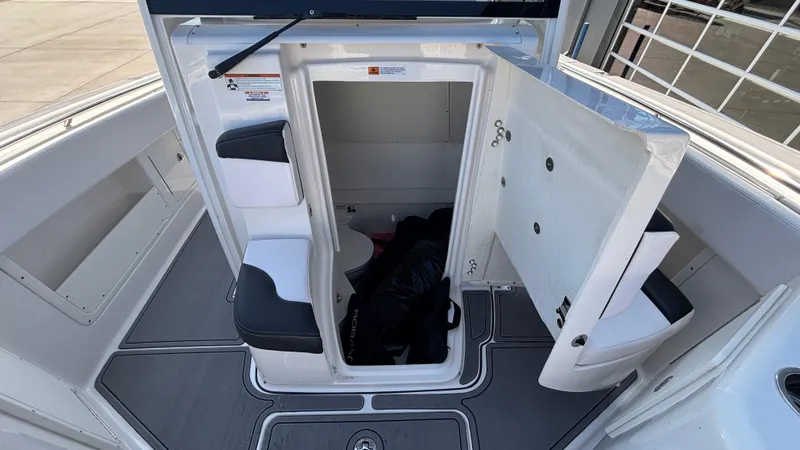 Slide: The Image of 2021 Robalo R302 Center Console boat interior with open storage compartment. - 18