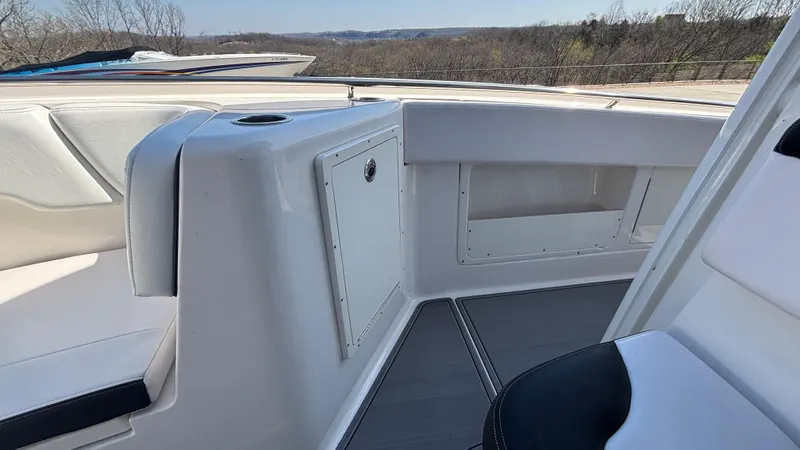 Slide: The Image of 2021 Robalo R302 Center Console boat interior with seating and storage compartments. - 19