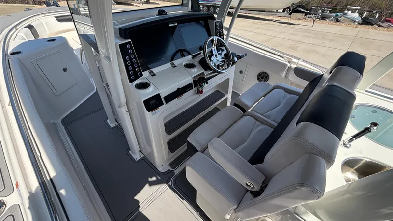 Slide: The Image of 2021 Robalo R302 Center Console boat interior with dual seats and modern dashboard. - 22