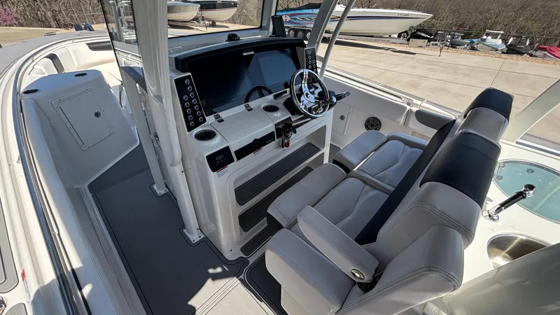 Slide: The Image of 2021 Robalo R302 Center Console boat interior with modern helm and seating. - 23