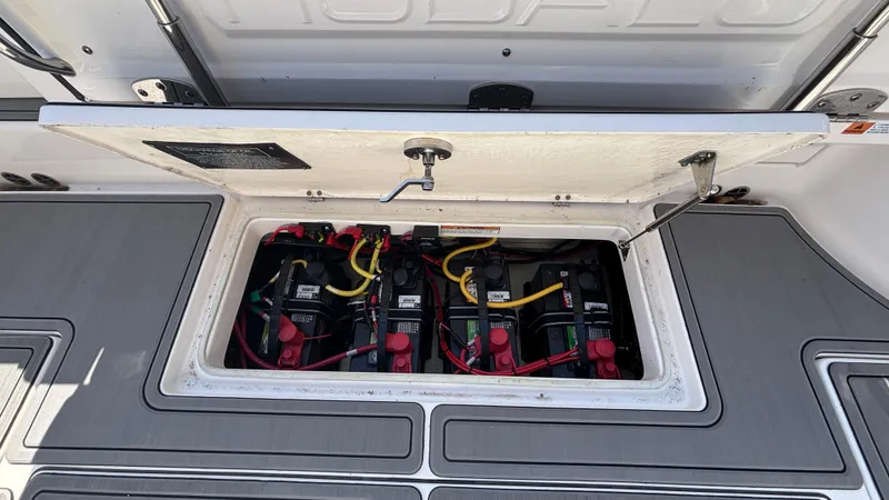 Slide: The Image of 2021 Robalo R302 Center Console battery compartment with multiple batteries and wiring. - 25